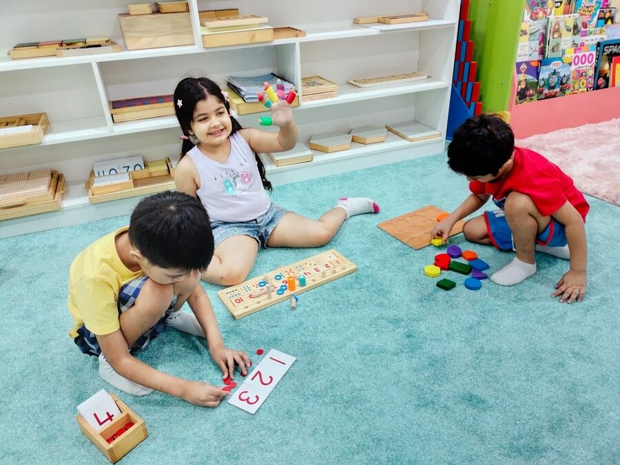 Children doing hands-on counting and shape-sorting activities